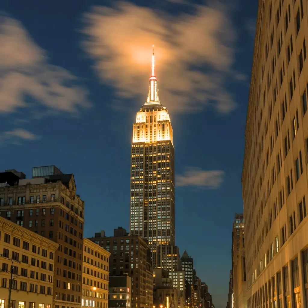 Empire State building litting up in the night time